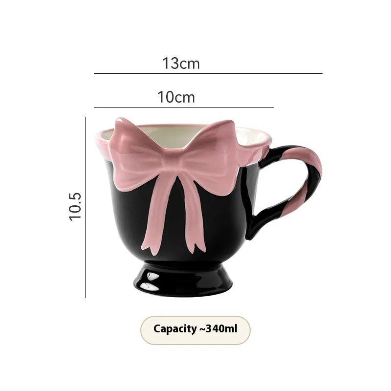 Ceramic mug with heart bow design in black pink and white powder colour options