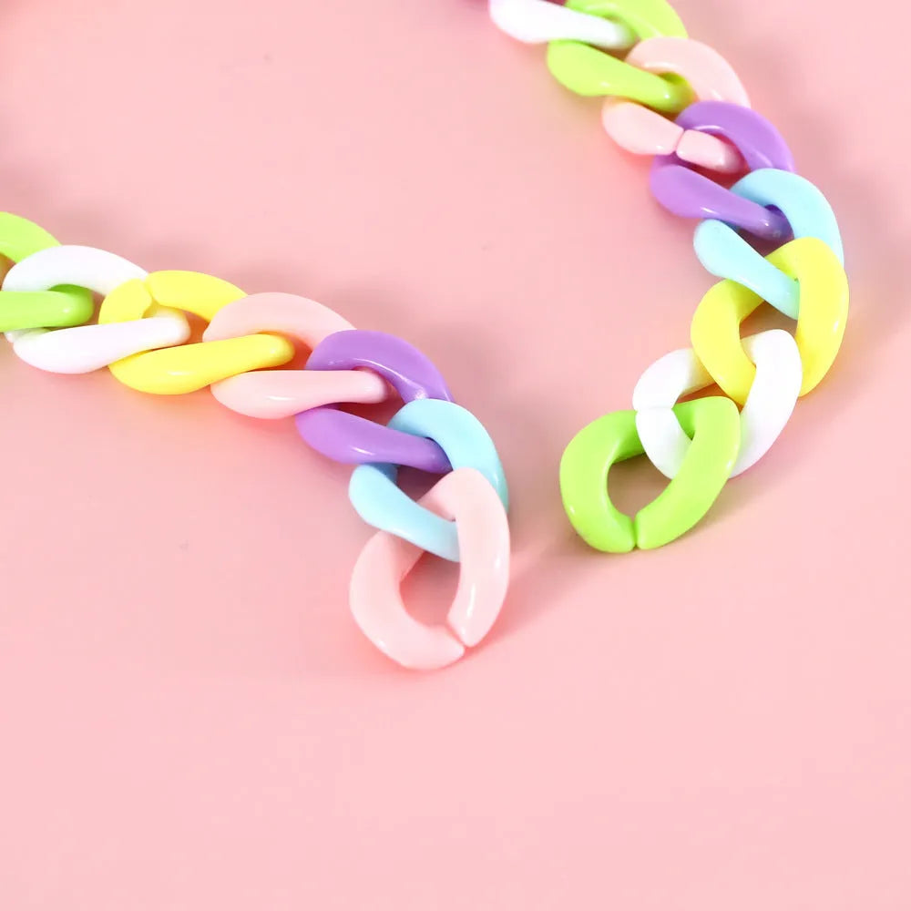Soft plastic pet collar in pastel macaron candy colours with a chain-link design, shown in S and M sizes.