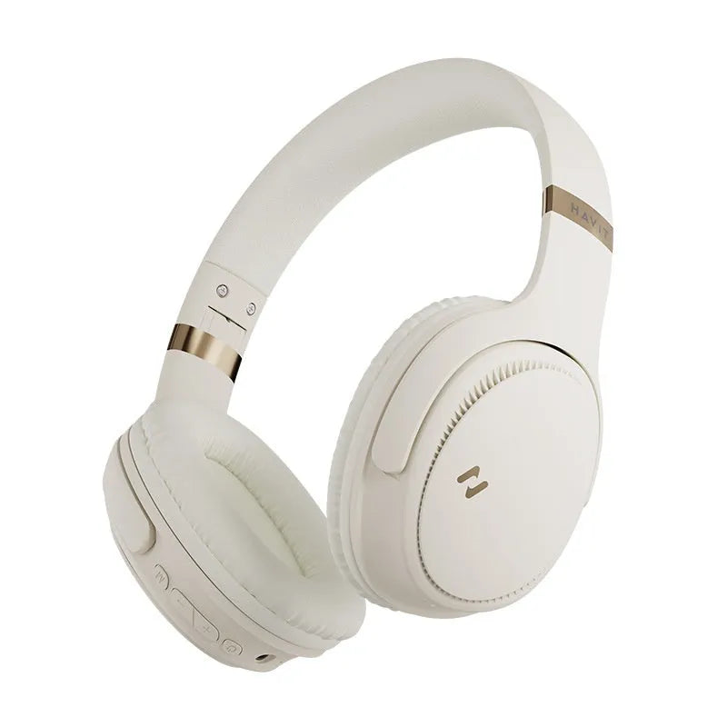 Cream coloured wireless Bluetooth over-ear gaming headset with microphone on a black background.