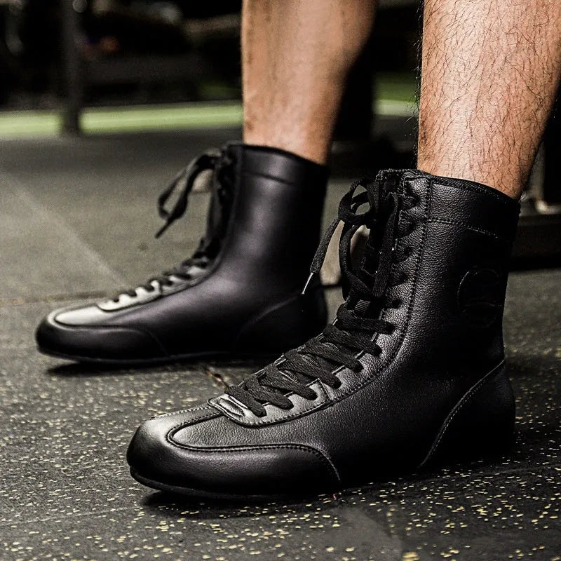 Professional black and gold mesh boxing shoes with a non-slip rubber sole for indoor training.