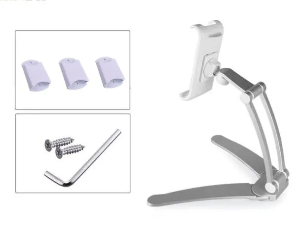 Silver aluminium alloy tablet stand with adjustable black clips holding a tablet, showing 360-degree rotation on a wooden desk.