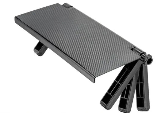 Black adjustable screen top shelf on a desktop monitor holding a streaming device and remote