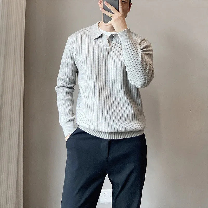 Man wearing a loose grey modal knit pullover sweater with a textured rabbit fur blend fabric.