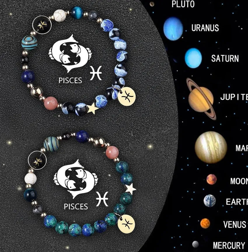 Two natural stone beaded bracelets with sterling silver zodiac charms on a wooden surface.