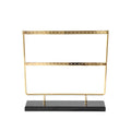 Alloy earring storage rack in green on a desktop holding multiple stud and hook earrings