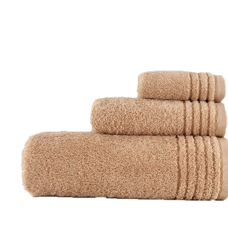 Cotton towel set in brown or beige showing bath sheet, hand towel, and face cloth sizes