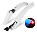 Mountain bike mudguard with quick-release design and rear tail light, black, on a front fork