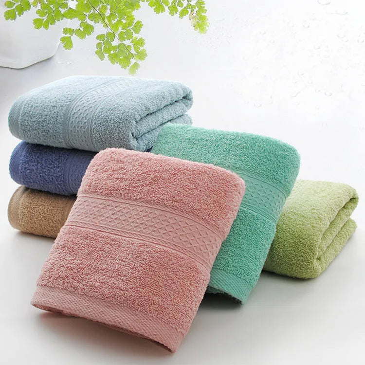 Thick bath and beach towels in seven colour options including apple green, dark blue, and light pink