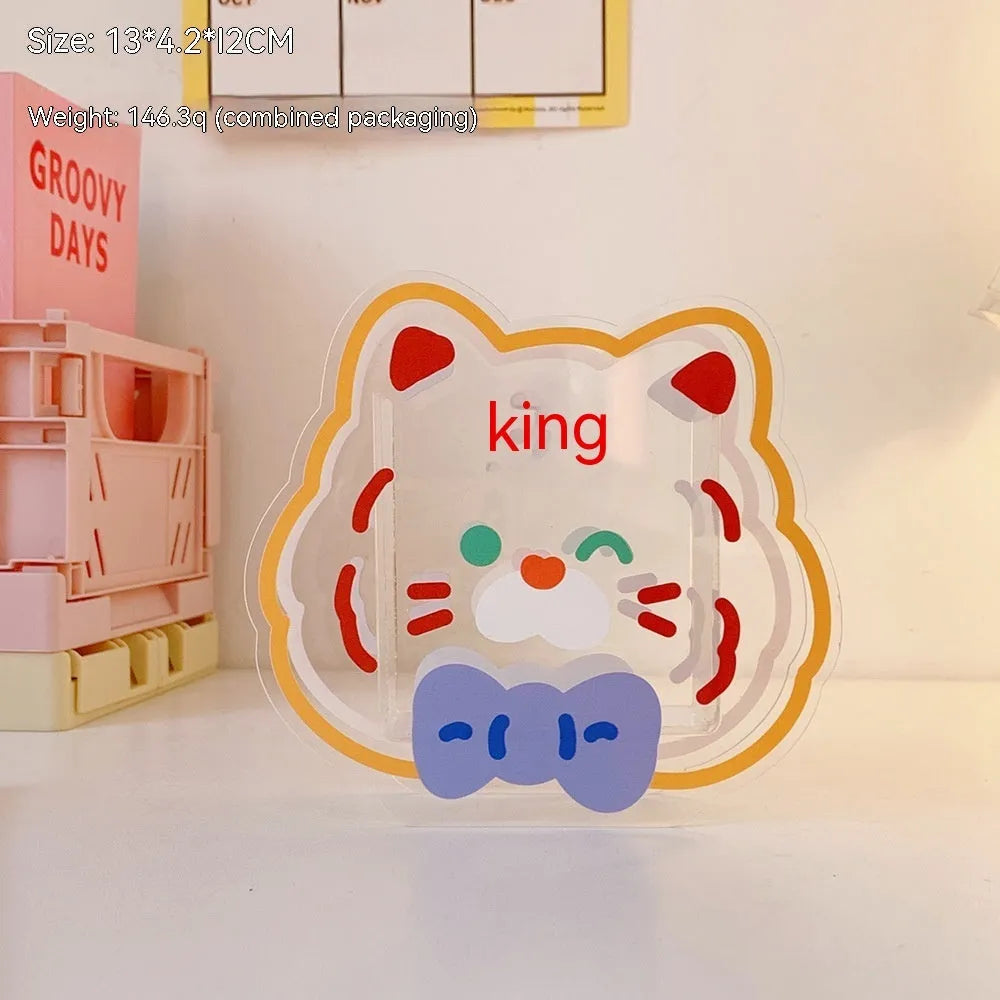 Clear square acrylic storage box with a colourful printed lid featuring a cute design, shown holding pens and stationery.