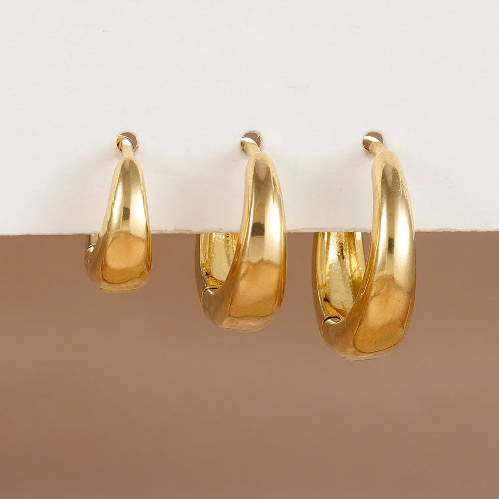Geometric copper earring set of 3 glossy gold electroplated round shape earrings on display