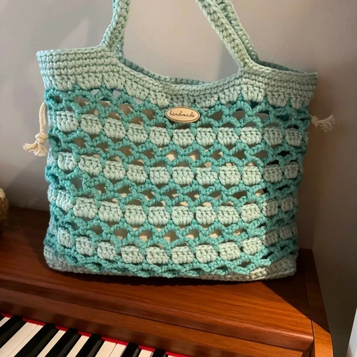 Handwoven wool summer tote bag with a floral patterned design.