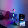 Black smart APP-controlled LED atmosphere light with 180-degree rotation on a desktop.