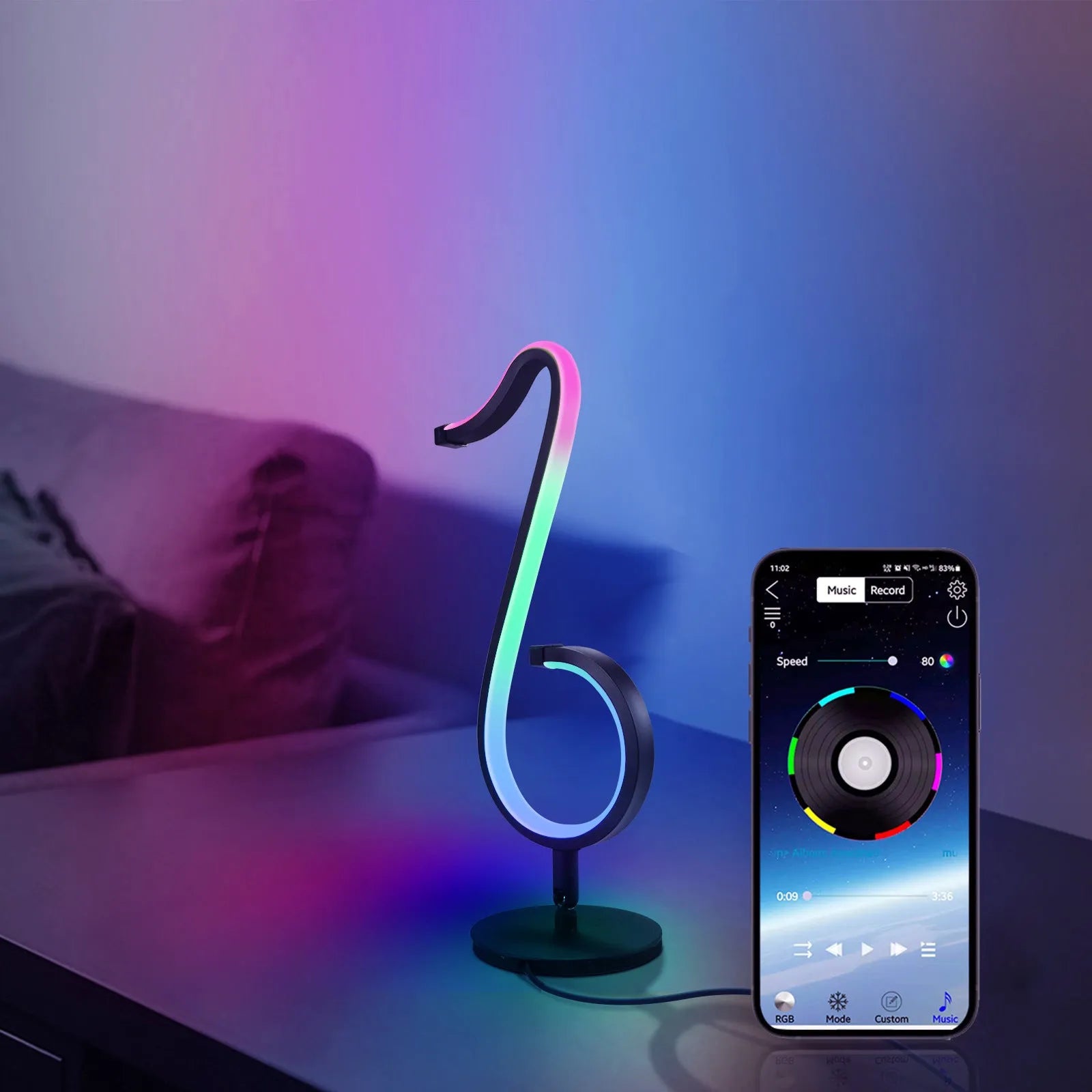 Black smart APP-controlled LED atmosphere light with 180-degree rotation on a desktop.