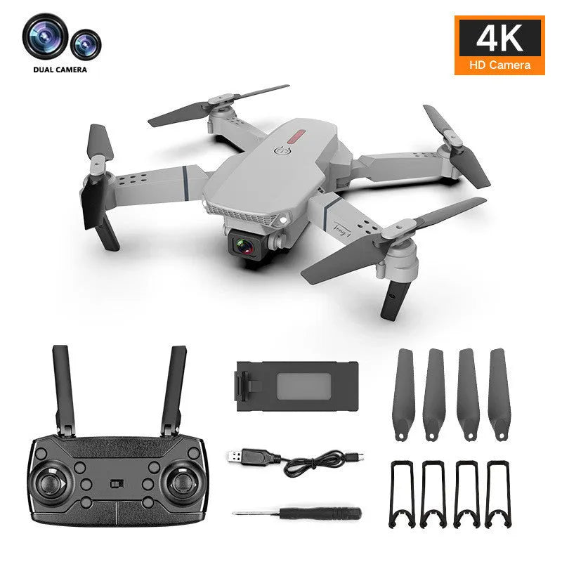 Grey foldable remote control drone with dual 4K cameras, LED lights, and a handheld transmitter.