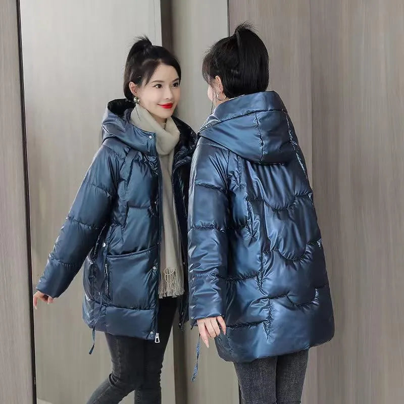 A woman's loose-fit hooded winter jacket in a poly-cotton blend, shown in a choice of colours including black and champagne.