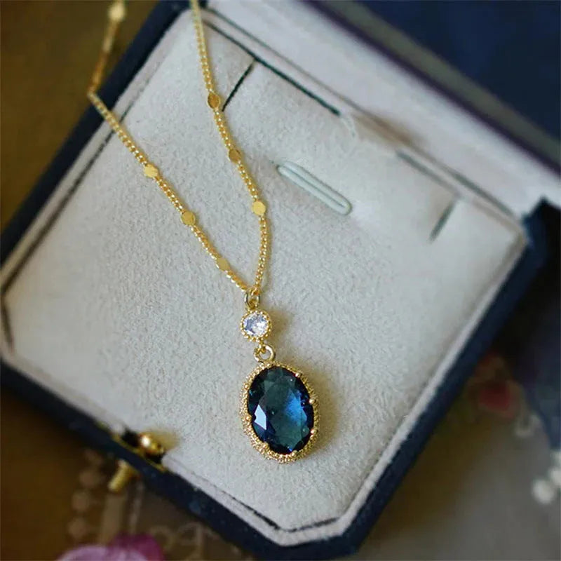 A gold-coloured geometric pendant on a copper chain necklace.