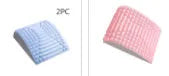 Blue back stretcher pillow for lumbar and neck support on a grey background.