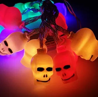 Halloween LED string lights with pumpkin, bat, and ghost decorations hanging on a wall