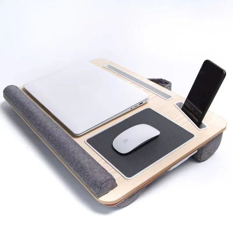 Foldable laptop desk in black walnut colour on a bed, showing open leg supports.