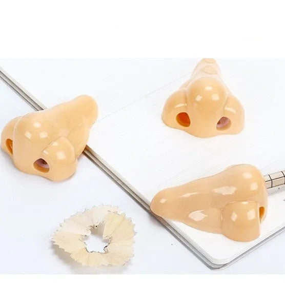 Flesh-coloured plastic manual pencil sharpener with a geometry shape and large nostril.