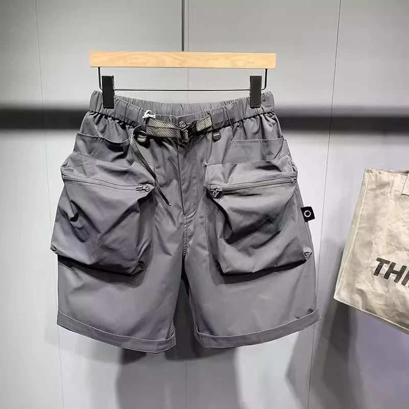 Men's black loose-fitting work shorts with elastic waistband and pockets, laid flat
