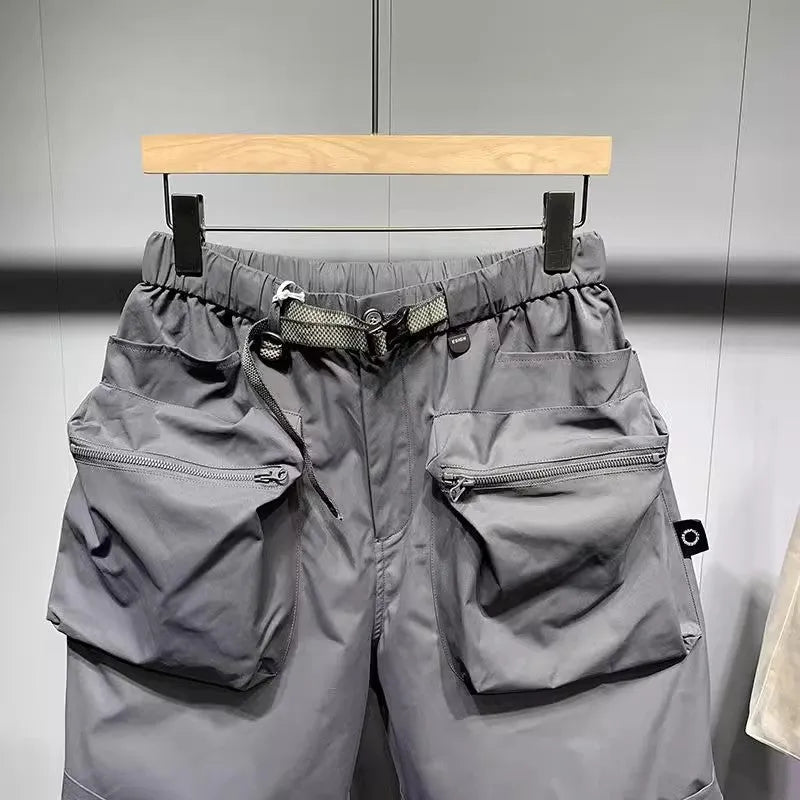 Men's black loose-fitting work shorts with elastic waistband and pockets, laid flat