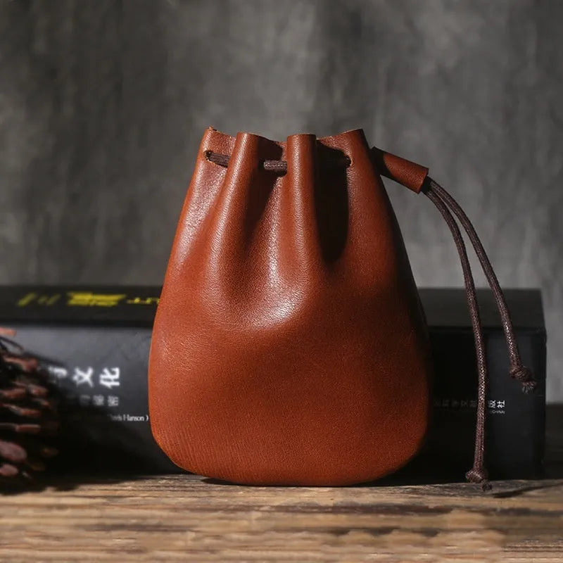 Vintage brown genuine leather drawstring bundle wallet with cinched closure.