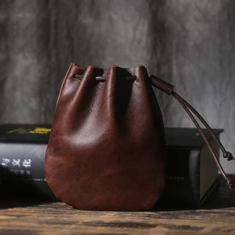 Vintage brown genuine leather drawstring bundle wallet with cinched closure.