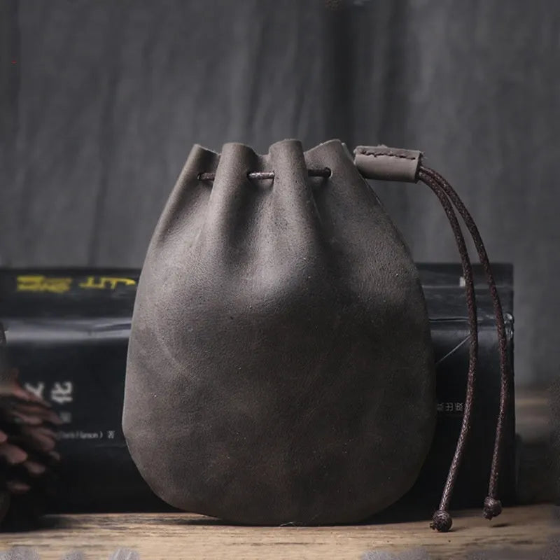 Vintage brown genuine leather drawstring bundle wallet with cinched closure.