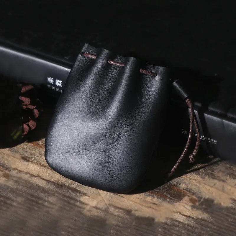 Vintage brown genuine leather drawstring bundle wallet with cinched closure.
