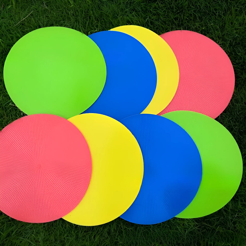 Soft yellow TPE football training target pad flat on grass, 23cm diameter.