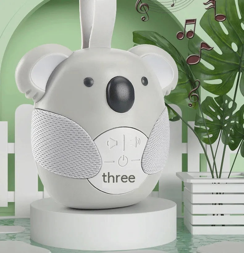 Koala-shaped infant white noise player toy in fox colour on a surface