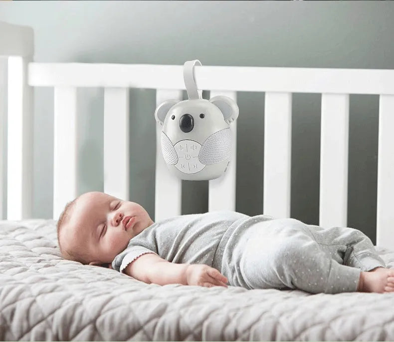 Koala-shaped infant white noise player toy in fox colour on a surface