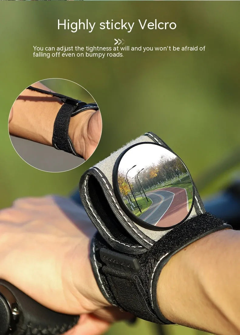 Black nylon bicycle rear-view mirror shown mounted on a cyclist's wrist.