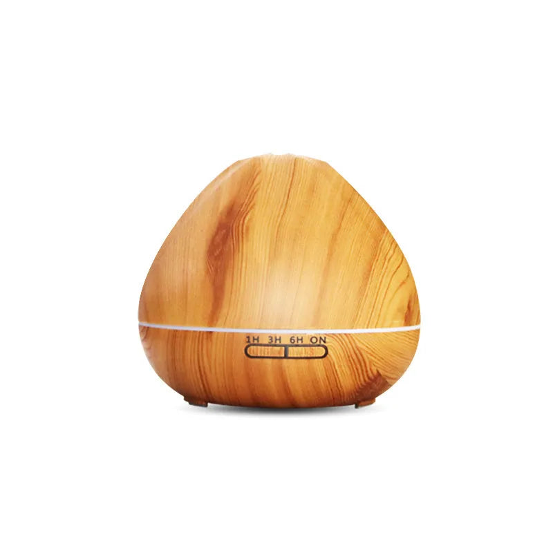 Air humidifier aromatherapy machine with 500ml capacity and light wood finish placed on a desk