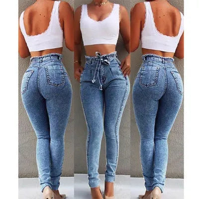 Pair of blue fringed jeans with a distressed hem laid flat, showing cowboy fabric texture.
