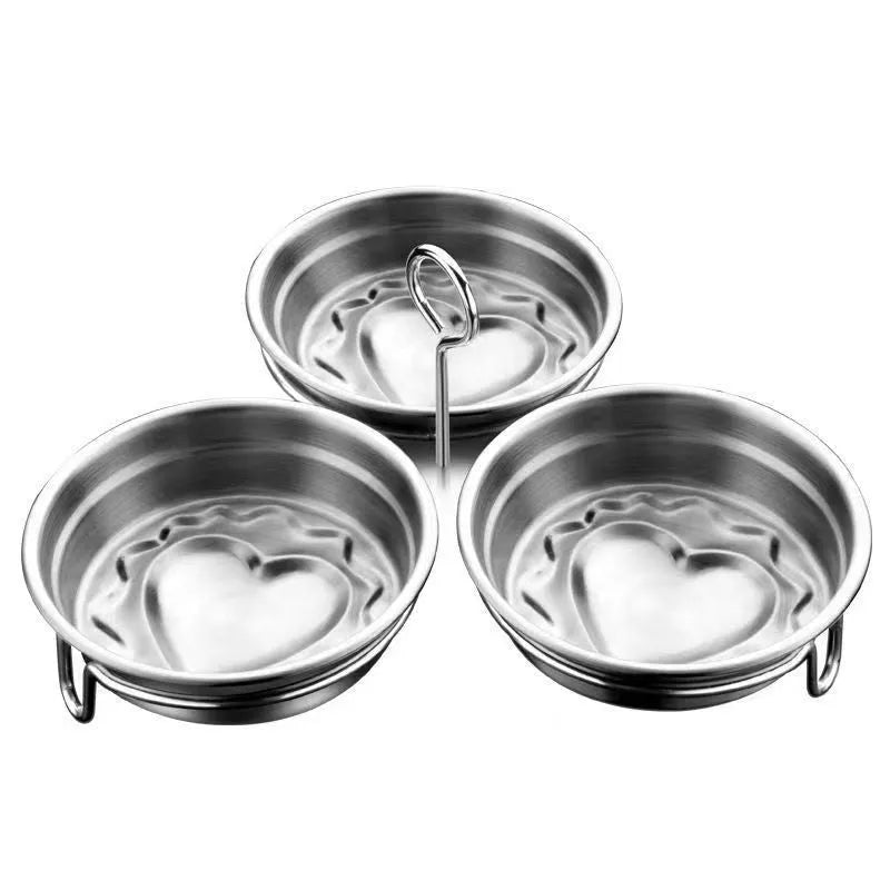 Mini heart-shaped stainless steel egg steamer for cooking a single egg.