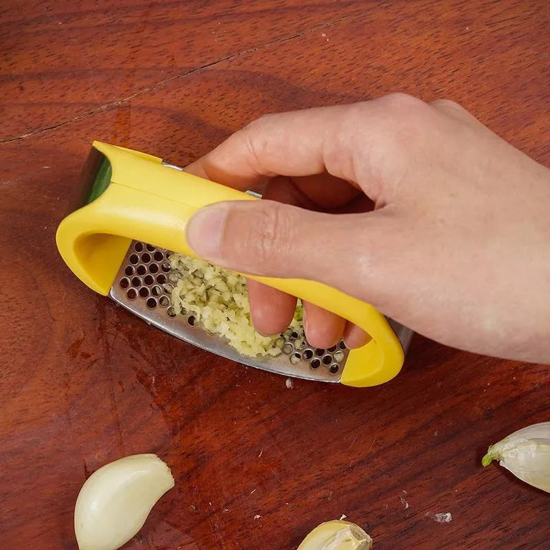 Stainless steel manual garlic press with ergonomic handle in assorted colours