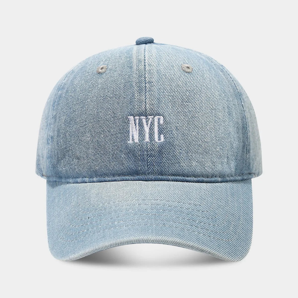 Adjustable denim peaked cap with a dome crown and a large English letter design on the front.