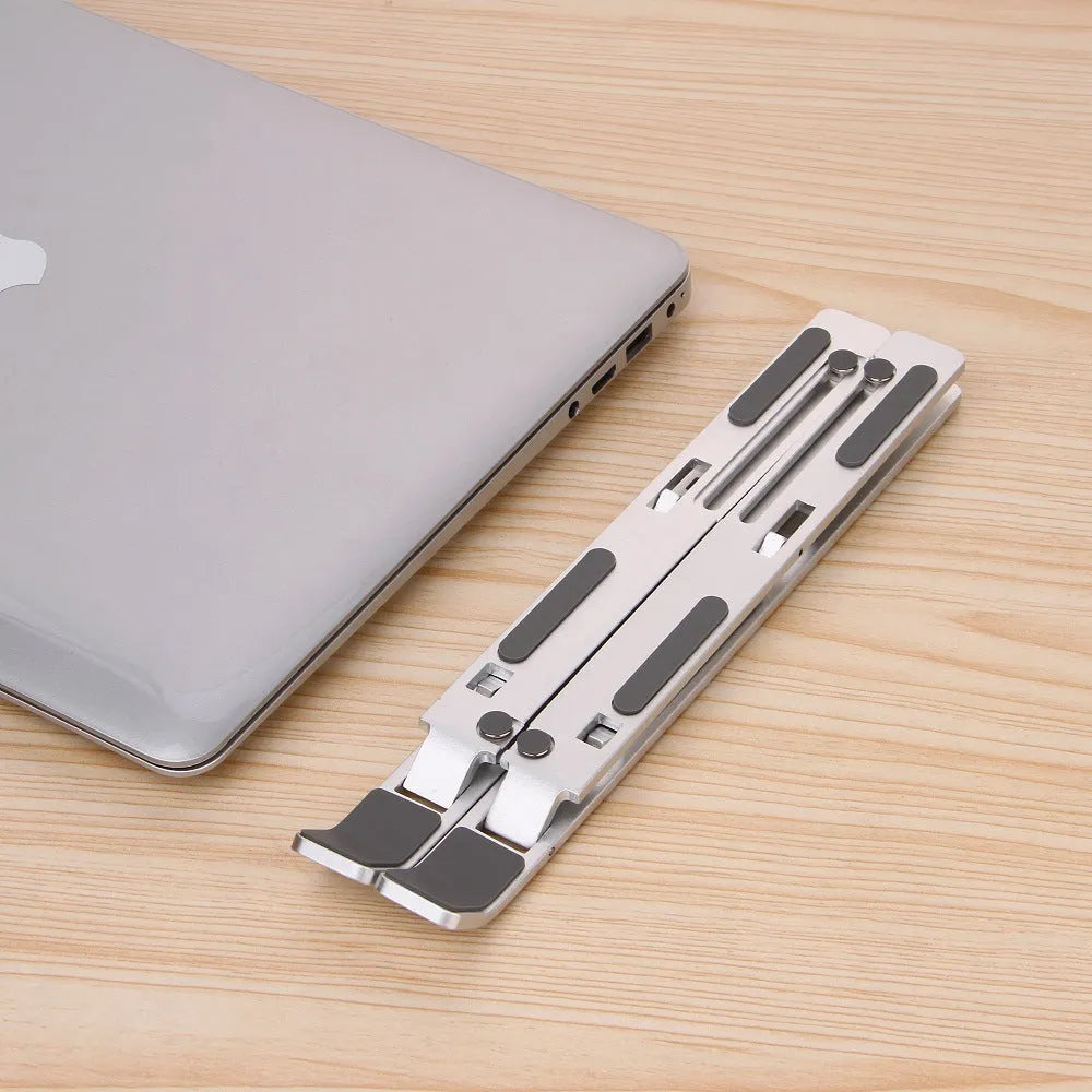 Silver aluminium alloy cooling folding computer stand for laptops under 16 inches on a desk