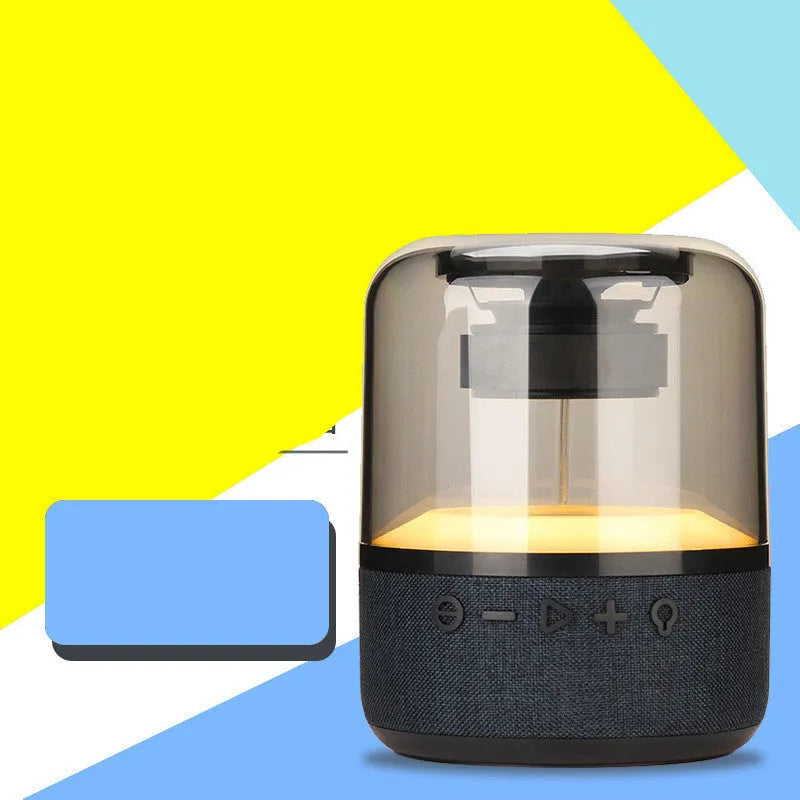 Black portable Bluetooth speaker with multi-colour LED light ring and control buttons on top.