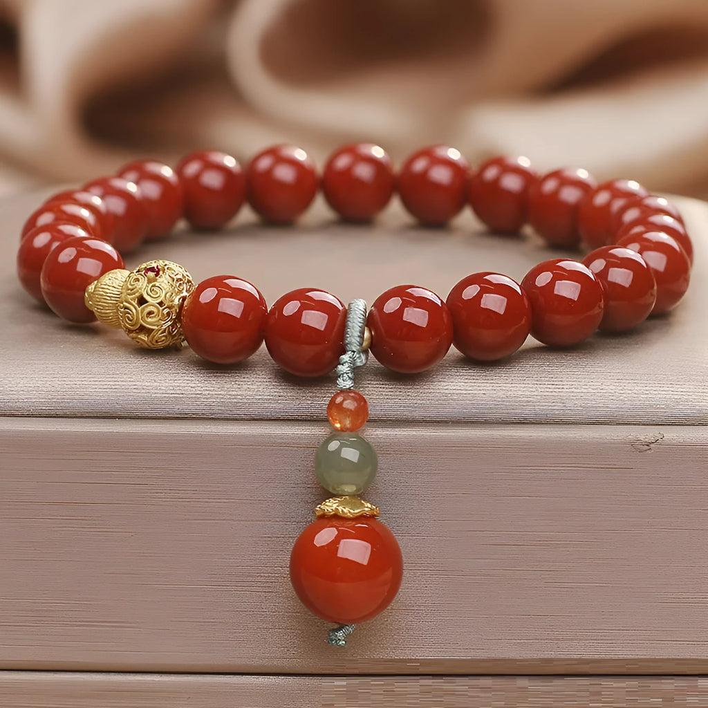 Red agate ethnic style bracelet for women on a plain background
