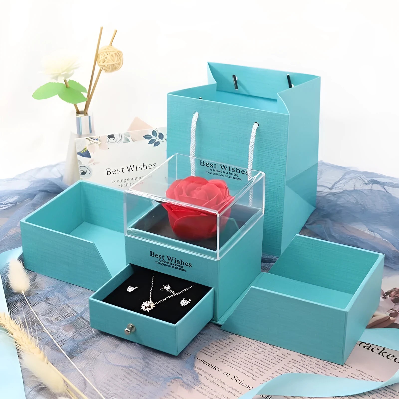 Blue jewellery gift box with a white plastic eternal flower on the lid
