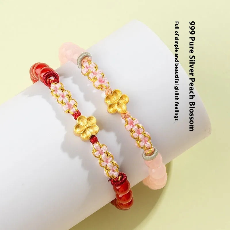 Hand-woven red rope bracelet with crystal centrepiece in Chinese peach blossom design