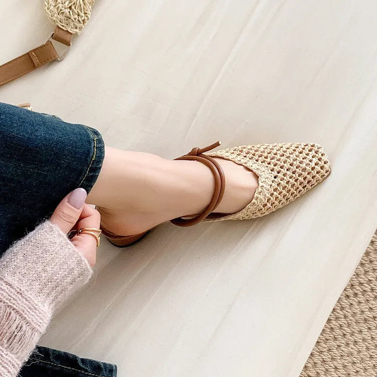 Women's beige square toe slippers with hollow-out design and a chunky mid-heel on a rubber sole.