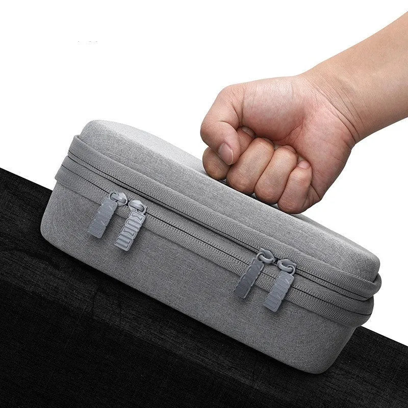 Black EVA digital storage bag with a handbag shape for organising headphones and cables.