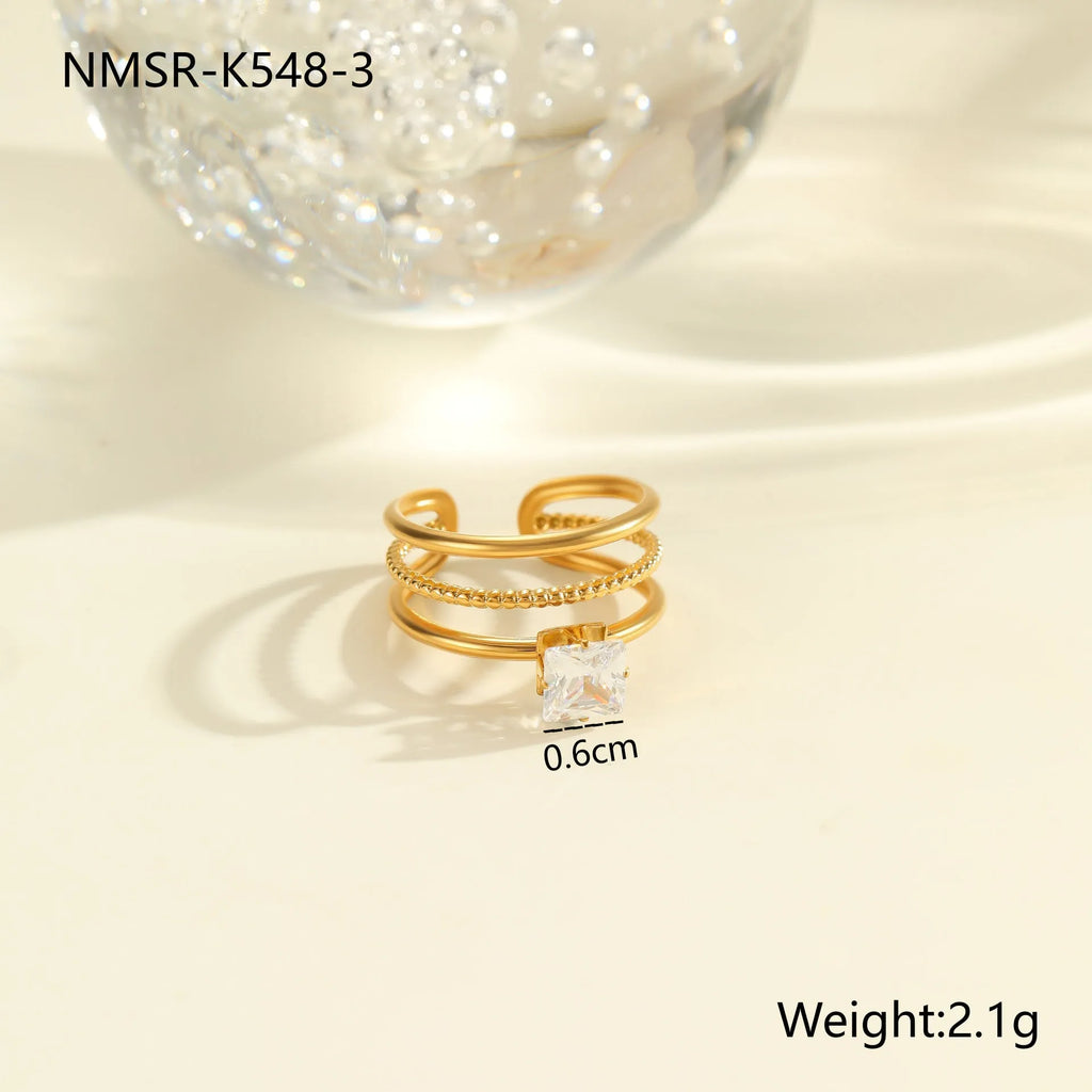 Gold electroplated stainless steel ring with zircon accents in open mouth geometry design