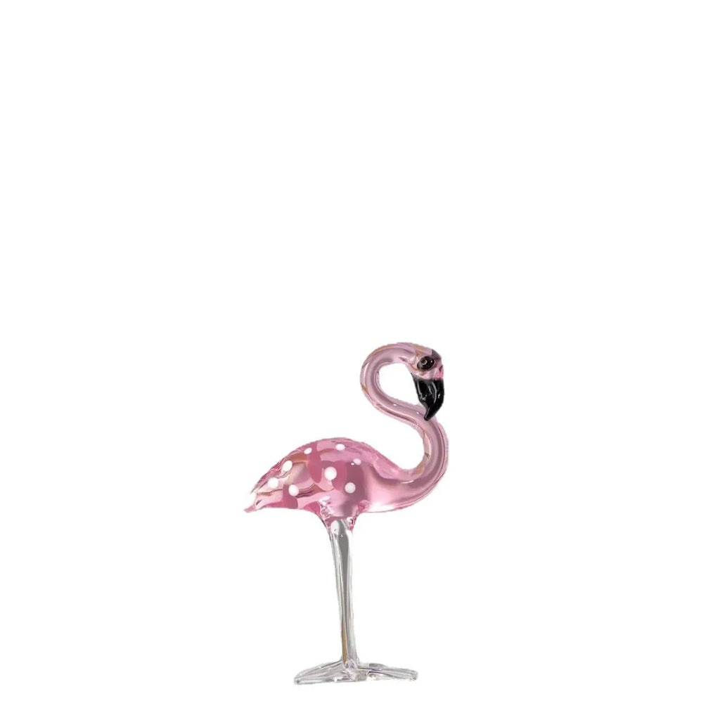 Pink crystal flamingo decorative ornament on a table for modern home decor.