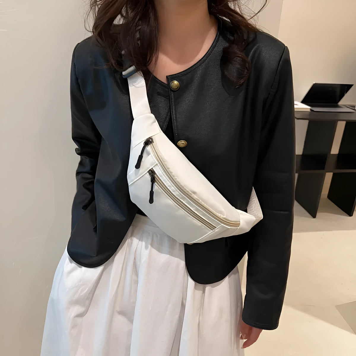 Soft nylon multi-layer mobile phone waist bag with crossbody strap, three-dimensional pocket, and sewing thread detail.