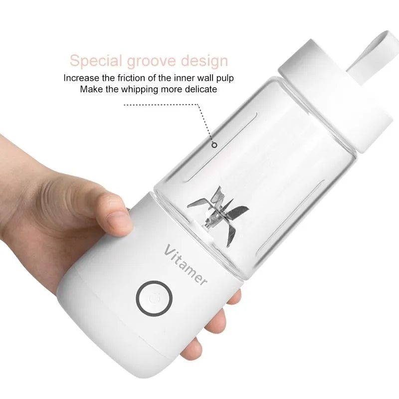 White portable USB rechargeable blender bottle with silicone lift ring, shown next to its charging cable.